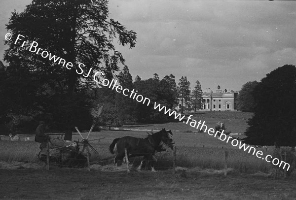 DISTANT VIEW OF HOUSE IN HARVEST TIME